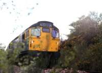 A class 27 runs through the old Rhu Station on the west <br>
Highland Line with a train for Glasgow Queen Street in June 1976.<br><br>[Johnny Trippick /06/1976]