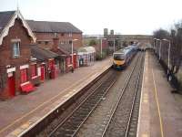 Layton, looking east towards Poulton-le-Fylde, as 185120 hurries through on a Manchester Airport service. In the background Crossley's Bridge, a typical Blackpool design, crosses the line and the former goods yard access. The goods yard is now occupied by a car park and the flats that can be seen. The semaphore distant is operated from Carleton Crossing signal box. <br><br>[Mark Bartlett 17/02/2009]