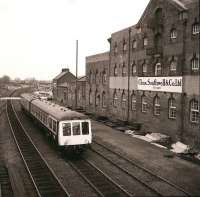 A Hull bound dmu runs into Driffield on 13 April 1983. The notable structure on the right is a former sugar beet mill which has since been demolished.<br><br>[Peter Todd 13/04/1983]