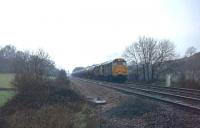 14 bogie oil tanks, presumably empty, are hauled up the 1:37 Lickey Incline without banking assistance, and the double headed Brush Type 2s sounded tremendous. Leading loco 31130 is now preserved on the Battlefield Railway but 31141 was withdrawn in 1989 and cut up the same year at M C Metals, Glasgow.<br><br>[Mark Bartlett 05/03/1980]