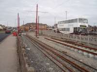 Refurbishment and relaying of the tramway north of Blackpool meant that the section to Cleveleys and Fleetwood was closed in winter 2008/09. Here is the section through Cleveleys showing relaying in progress and the maintenance gang's dedicated bus parked alongside. This picture looks north towards Fleetwood. [See image 31563] for the same location around eighteen months later. <br><br>[Mark Bartlett 17/02/2009]