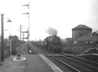 One of Ayr shed's <I>Crab</I> 2-6-0s no 42917 approaching Glengarnock station northbound in March 1965 hauling mineral wagons. [Etched in the memory as, after passing through the station, the locomotive proceeded to shunt back into the steelworks sidings to the north. When our train to Paisley pulled out a short time later, we passed a small gathering in the sidings discussing how best to get the derailed wagons back on the road!]<br><br>[Colin Miller /03/1965]