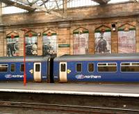 A Northern DMU stands in the bay below the impressive mural at the south end of Carlisle station on 19 February 2009. The plate reads <I>150 years of Carlisle's Citadel Station</I>.<br><br>[Colin Alexander 19/02/2009]