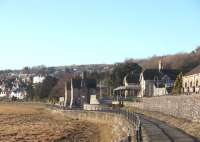 The heavy stone construction of Grange-over-Sands station looks like it was designed to stand the worst of storms. In fact the coast faces east at this point and is very sheltered. The climate is noticeably mild too so the promenade alongside the line is noted for its palms and colourful plants.This picture looks towards Ulverston. <br><br>[Mark Bartlett 17/01/2009]