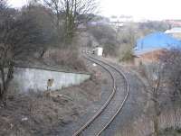 The line serving North Queensferry's first station and pier gained a junction when the Rosyth Naval Base opened in Edwardian times and this is the location where the lines parted. The line from here to North Queensferry closed in the 1950s, but the relative newcomer survives. The branch leaves the main line at Inverkeithing South Junction a mile in the distance, but the main line rises so quickly (for the Forth Bridge) that it is already high above on the Jamestown viaduct. This seldom-used line retains a loop controlled though the ground frames at either end called Naval Base North and Naval Base South (in middle distance).<br>
<br><br>[David Panton 22/02/2009]