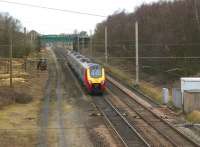 A Virgin Voyager set heads north on the WCML between the former stations at Standish and Coppull on 21 February 2009. Work is in progress thinning out the trees on the embankments which have taken hold over the past years. The work on the west side of the line is made much easier by the ability to access the site along the trackbed of the former slow lines.<br>
<br><br>[John McIntyre 21/02/2009]