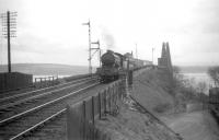 Gresley class D49 4-4-0 no 62708 <I>Argyllshire</I> brings the 3.43pm Edinburgh Waverley - Ladybank train off The Forth Bridge and coasts down the hill into North Queensferry station in April 1959. The locomotive spent most of its life at Thornton Junction shed, from which it was withdrawn the month after this photograph was taken.<br><br>[Robin Barbour Collection (Courtesy Bruce McCartney) 15/04/1959]