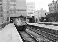 26043 stands at platform 6 at the north end of Aberdeen station on 30 September 1981 with the 1530 to Inverness boarding. Note the 2-storey former north end booking office centre right, with the bricked up entrances to the old platform 9 stairway and cross-station walkway still clearly visible. [See image 12660 taken from a similar viewpoint during the north end demoliton work in 1973]<br><br>[Peter Todd 30/09/1981]