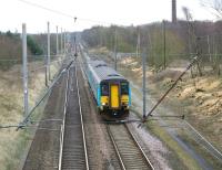 Framed by the overhead line equipment 156488 heads north from Standish with a service to Blackpool North on 21 February 2009.<br>
<br><br>[John McIntyre 21/02/2009]