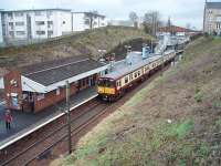 314203 rolls in to a wet Mount Florida station on a Cathcart outer circle service. This station, in addition to serving Hampden Park, also caters for Langside College, accessed directly from the station footbridge. <br><br>[Mark Bartlett 26/02/2009]