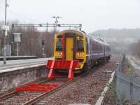 Scotrail 158713 pulls away from the bay platform at Anniesland heading back to Glasgow Queen St HL via Maryhill on a wet afternoon. Because the relaid line from Maryhill is a stub and has not been connected into the other lines at Anniesland the signalling has not been complicated by the new service.<br><br>[Mark Bartlett 26/02/2009]