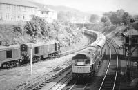 A BRCW Type 2 propels the empty stock of a special out of the station past Largs signal box in June 1967, past a pair of EE Type 1s in goods yard siding.<br><br>[Colin Miller /06/1967]