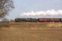 70013 <I>Oliver Cromwell</I> heading west with a special to Newport via Bristol Parkway and the Severn Tunnel on 1 March. Taken on the GWR mainline close to the village of Uffington about ten miles east of Swindon. The engine had just taken water at Challow and was accelerating away with great gusto. Very pleasing to the ear.<br>
<br><br>[Peter Todd 01/03/2009]