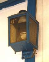 A lamp with the remains of an old waterslide transfer still attached, identifying its origins as <i>Ach....</i>, photographed at Taynuilt in October 1998. It was presumably salvaged from the former Ach-na-Cloich. (Once the next station westbound - closed in November 1965.) Note that, unlike the C & O station name, the spelling of the name of the local village on the south shore of Loch Etive is <I>Achnacloich</I>.<br><br>[Colin Miller 08/10/1998]