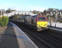 Formed of EWS stock but run by First ScotRail this set beefs up commuter services on the Fife Circle with an Inner in the morning and an Outer in the evening, so in terms of getting into Edinburgh (mostly what it's about) it's the western (Dunfermline) half of the circle which benefits. An all maroon train with a proper engine (though, let's face it, not a pretty one) it attracts stares from onlookers though seeming indifference from passengers. 67008 is the locomotive, photographed at North Queensferry on 4 March 2009.<br><br>[David Panton 04/03/2009]