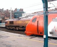 EWS 66103 takes a northbound freight through platform 4 at Carlisle on 19 February as a Voyager boards at platform 3.<br><br>[Colin Alexander 19/02/2009]