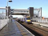 170 458 pulls into Edinburgh Park station on 4 March to drop off a few late commuters and carry the rest on to Haymarket and Waverley.<br><br>[David Panton 04/03/2009]