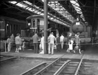 Visitors admire the exhibits at an open day at London Transport's Neasden Depot in May 1963 ....with the current presumably switched off!<br><br>[Robin Barbour Collection (Courtesy Bruce McCartney) /05/1963]