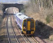 158 730 approaches Dalgety Bay with a Kirkcaldy service on  27 February 2009, passing a sign on the Up side reading <I>End of Poor Adhesion</I>.  The train is entering a section where a stiff upgrade and trees hard by the line mean that on a wet day in autumn trains can have difficulty getting going after a stop at <I>The Bay</I>.<br>
<br><br>[David Panton 27/02/2009]