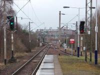 Looking west from Kings Park, Cathcart East junction can be seen. The green aspect indicates the next train is going straight ahead and will drop under the Cathcart line to john the inner circle near Mount Florida. The line to the left is the double track link with Cathcart West Juction for the Outer Circle or Neilston. The line on the far right is the chord running in from the Outer Circle to Kings Park and Newton beyond.<br><br>[Mark Bartlett 26/02/2009]