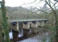 The westerly bridge at Caton Crook O Lune is more difficult to see than its sister bridge to the east. [See image 18602] They are both impressive structures, now limited to carrying a cycle path since closure to trains in 1966. View west towards Halton and Lancaster at Map Reference SD 520647. <br><br>[Mark Bartlett 13/03/2009]