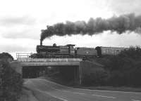 Preserved ex-S&D 2-8-0 no 53809 in full flight crossing the A303 adjacent to Weyhill Station in September 1987 en route from Andover to Ludgershall on the stump of the M&SWJ line.<br>
<br><br>[Peter Todd 27/09/1987]