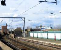 Looking west from Deansgate station on 5 March 2009. From here the line snakes over a viaduct, then runs below the bridge that once carried trains into Manchester Central. Today the bridge is used by the Manchester Metrolink and one of their trams can be seen heading into the city centre.<br>
<br><br>[John McIntyre 05/03/2009]