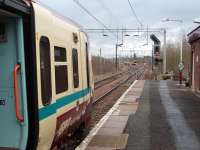 314209, in the Newton reversing spur, waits for 334027 to leave Newton station for Dalmuir before drawing forward to form a Glasgow Central (via Kings Park/Outer Circle) service. The electrfication masts to the left of the reversing siding show the course of the West Coast Main Line towards Motherwell. <br><br>[Mark Bartlett 26/02/2009]