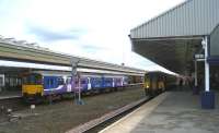 Class 150 variations pass at Bolton on 5 March 2009. On the left, heading for Manchester, is unit 150136, while on the right is 150275 with a train for Preston.<br>
<br><br>[John McIntyre 05/03/2009]