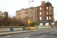 The entrance to Junction Bridge station, opened by the Edinburgh, Leith and Newhaven Railway in 1846 (closed 1947), is now occupied by the metal railed section of the parapet seen here on the west side of the bridge carrying Great Junction Street over the Water of Leith. The platform below the bridge [see image 22902] stood on the north bank of the river with a stairway linking it with the former street level booking office. <br><br>[John Furnevel 15/03/2009]