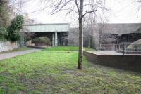 Standing on the site of the platform at Junction Bridge in 2009 looking towards North Leith. The station, a stones throw from North Leith terminus, opened as Junction Road in 1846. From here the line ran under the bridge on the left and through a (now filled in) tunnel below Coburg Street to emerge at North Leith terminus. (For a view of the North Leith end of the tunnel [see image 22862].) Access to the station was from a booking office on the bridge running across the picture carrying Great Junction Street (its former position on the bridge can be seen directly beyond the tree in the centre). The Water of Leith runs by on the right. Junction Bridge station closed in June 1947.     <br><br>[John Furnevel 15/03/2009]