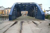 The Victoria Swing Bridge, dating from 1874 and which, at one time, provided a link across the Water of Leith between the eastern and western sections of Leith Docks. The bridge originally swung open to give access to the inner harbour and the two old docks running parallel with Commercial Street. Photographed on a Sunday morning in March 2009 surrounded by the penthouses of the new Leith. Note the old rails still in place. Today the bridge provides a pedestrian link between what are now known as Ocean Drive and Rennie's Isle (opposite). <br>
<br><br>[John Furnevel 15/03/2009]