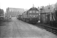 Scene in the yard at Galashiels in March 1969. This particular trip over the Waverley route (by then freight-only) had attached a number of brake vans carrying members of Edinburgh University Railway Society, whose plate is displayed on the front of the locomotive.<br><br>[Bruce McCartney /03/1969]