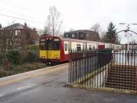 A Newton to Glasgow (via the Outer Circle) train, formed by 314209, pauses by the distinctive entrance to Langside's elevated island platform. <br><br>[Mark Bartlett 26/02/2009]