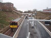 Mount Florida station's island platform and booking office building are seen from the northerly staircase entrance looking towards Cathcart as 314209 calls on its way to Neilston. <br><br>[Mark Bartlett 26/02/2009]