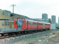 Scene at Broomloan Depot in Govan during the Glasgow Subway modernisation in the 1970s, probably around 1979, showing a couple of the older cars, one of which looks like the unique centre - door unit.<br><br>[Colin Miller //1979]