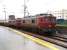 Two 2550 Class 25kv AC electric locos double head a cement train south through a wet but warm Porto Campanha station. 272-568-5 and 272-553-7 were built by Soreframe-Henschel from 1963. This class of locos is still in front line freight service with CP Rail. <br><br>[Mark Bartlett 08/02/2007]