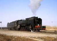 QJ 2-10-0 no 6838 at Daban, Northern Mongolia on 11 April 2000. Running back down onto a recently arrived passenger train, it will take the train on for another 100 + miles.<br><br>[Peter Todd 11/04/2000]