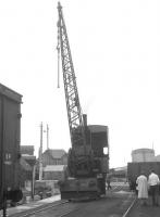 Scene on the quay at Mallaig, with a George Russel & Co (Motherwell) crane in steam. The note on the print says... <I>crane in use as a shunter - Mallaig - July 1963</I>. <br>
<br><br>[Colin Miller /07/1963]