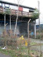 Looking west towards Granton Road from the trackbed of the former Newhaven station on 15 March 2009. The old booking office still looks over the platform remains from its lofty position on Craighall Road.<br><br>[John Furnevel 15/03/2009]