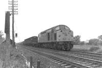 An EE Type 4 with a southbound freight at St Germains level crossing, around the late 1970s.<br><br>[Bruce McCartney //]