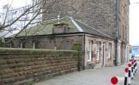 At first glance, no 94 Newhaven Road, seen here in March 2009, might appear to be a bungalow attached to a tenement block. Not so. The building formed the entrance to the Edinburgh, Leith & Newhaven Railway's 1846 station at Bonnington on the North Leith branch and is part of a two storey building linking to the platform below [see image 23036] - the tenements actually came later! Bonnington station was closed to passengers in June 1947 but the line remained open for freight for another 20 years or so.<br>
<br><br>[John Furnevel 15/03/2009]