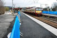 Platforms at Dumbarton Central are being re-surfaced. Even the trees in the former platform to the left are being cut back.<br><br>[Ewan Crawford 30/03/2009]