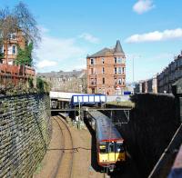 An outer circle service leaves Crosshill amidst the tenements on the south side of Glasgow.<br><br>[Ewan Crawford 29/03/2009]