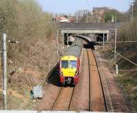 Standing on Cumbernauld Road bridge, directly above the site of Haghill Junction, on 2 April 2009. View north as a train for Springburn is about to run under the A8 into Alexandra Parade station.<br><br>[John Furnevel 02/04/2009]