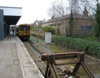 Looking like it hasn't been through the carriage cleaning plant at Kirkdale recently, Merseyrail EMU 507003 waits at Ormskirk with the next service to Liverpool Central on 30 March 2009. The old down platform (now out of use) retains its building, although no longer in railway use and with some alterations.<br>
<br><br>[John McIntyre 30/03/2009]