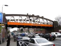 View along Great Western Road at Anniesland station on 1 April 2009, showing what is probably the most prominent overbridge still to have the image before last still in place.<br><br>[David Panton 01/04/2009]