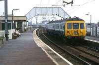 A well kept Clydebank station on 4 May 1985 with an afternoon service for Dalmuir arriving.<br><br>[Mark Dufton 04/05/1985]