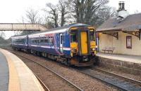 Glasgow Central - East Kilbride service arriving at Busby on 6 April. The former station building on the right is now <I>The Shanghai Express</I> Chinese restaurant.<br><br>[John Steven 06/04/2009]