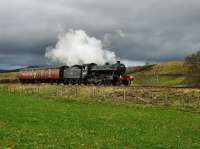 Under a leaden sky 61994 <I>The Great Marquess</I> with  a support coach approaching Kingussie on its way to Inverness. This engine is due to haul a special to Kyle of Lochalsh on Saturday 11/04/09.<br><br>[John Gray 09/04/2009]